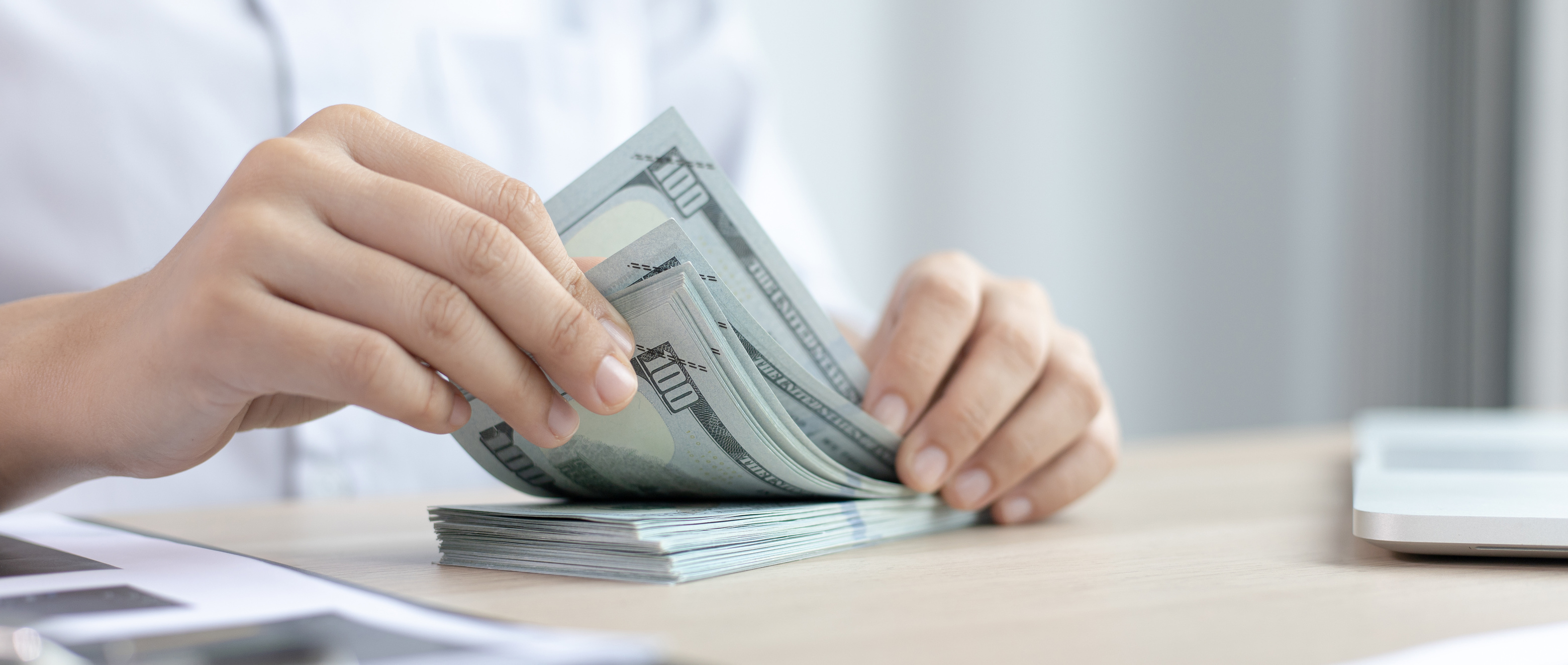 Woman Counting Bills for Financial Savings