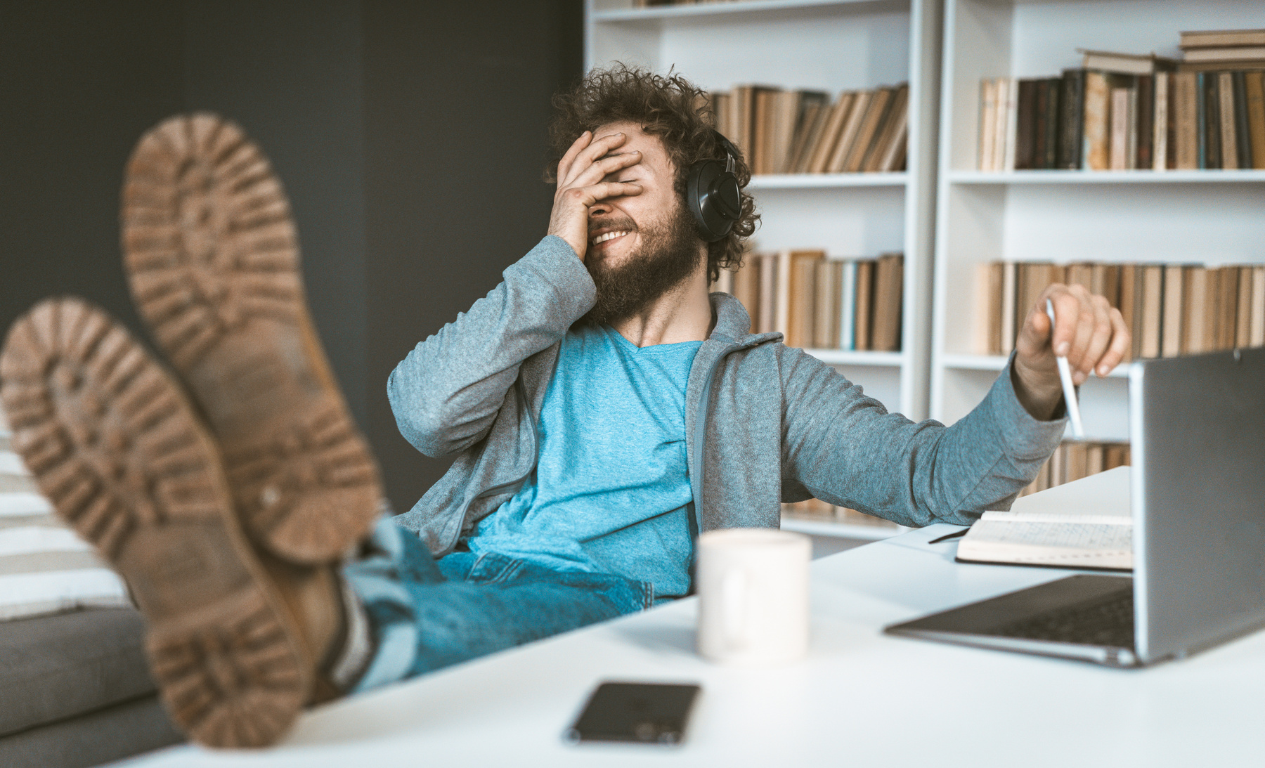 Man Facepalms While Working From Home
